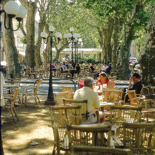View of pavement cafés in l’Ile-Rousse on Corsica, France