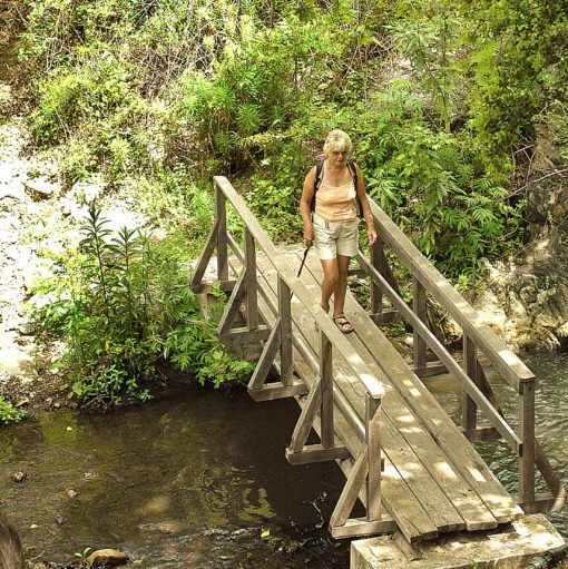 View of walker crossing a wooden bridge on Lesvos, Greece